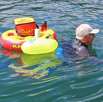 mike turner aqua jogs in a lake with floats behind him mike turner aqua jogs in a lake with floats behind him