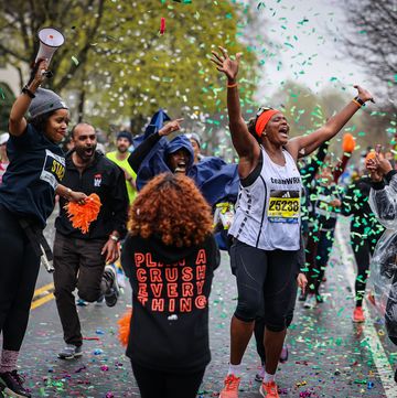 a runner gets a boost from spectators at the mine 21 cheering section of the 2023 boston marathon