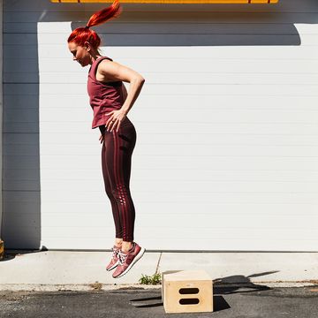 RWD woman doing a rep of a box jump