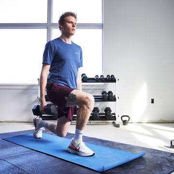 a runner doing a lunge with dumbbells