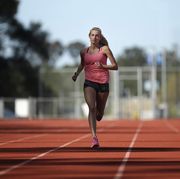hiit training, high intensity interval training, a female athlete runs on a track