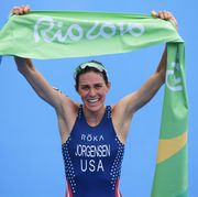 gwen jorgensen holds up the tape after winning rio 2016 triathlon