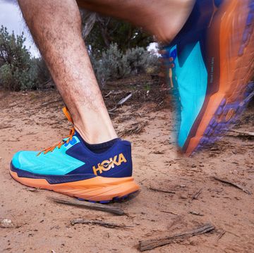 hoka zinal worn by a male runner on a trail
