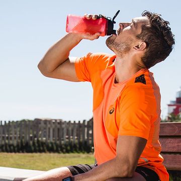 man drinking from sports bottle