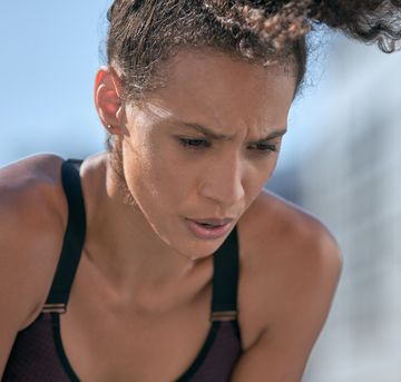 I just need to catch my breath, why do i run out of breath so easily woman in sports bra breathing heavily