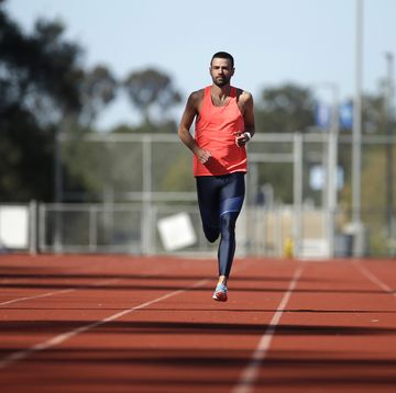 A male athlete runs on a track a male athlete runs on a track