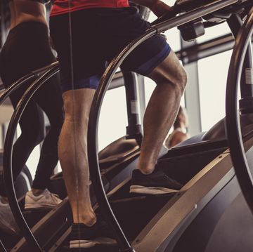 male athlete using stair climbing machine in the gym