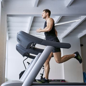 Man running on treadmill at gym man running on treadmill at gym