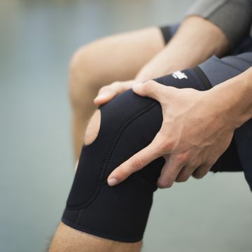 Man wearing knee brace, cropped man wearing knee brace, cropped