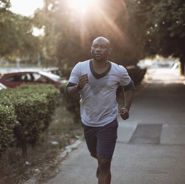 Photo of a young athletic man running morning run