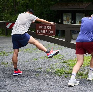 RWD pre run warmup two runners warm up at a trailhead