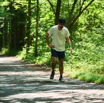 a runner looking tired after a run on a gravel trail a runner looking tired after a run on a gravel trail