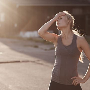 runner resting on suburban street