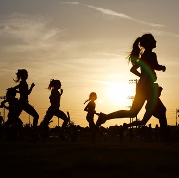 Runners compete in a 5k at sunset in Corona, California. runners compete in a 5k at sunset in corona, california