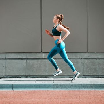 Shot of a young woman running outside shot of a young woman running outside