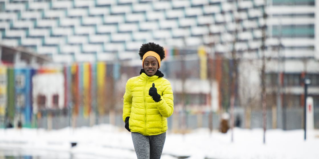 Young African woman training outdoors in bad weather young african woman training outdoors in bad weather