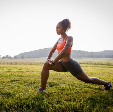Young female runner stretching in rural park young female runner stretching in rural park