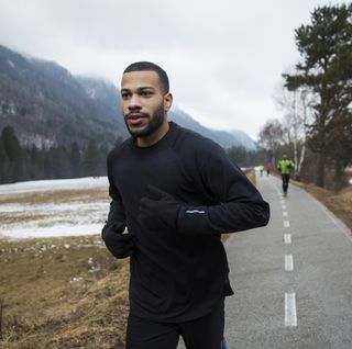 young man running on road